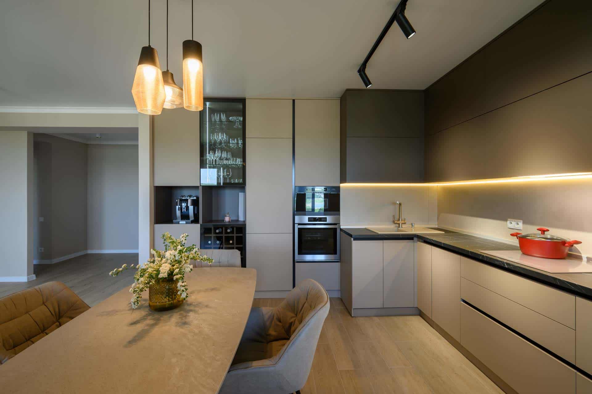 Maximizing Kitchen Storage. Large modern grey luxurious kitchen and dining room in studio apartment