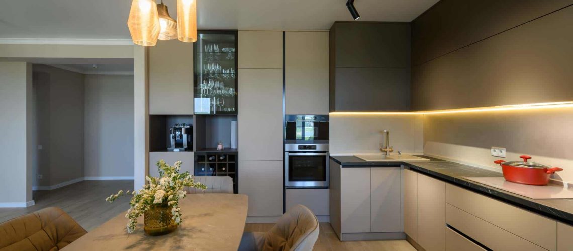 Maximizing Kitchen Storage. Large modern grey luxurious kitchen and dining room in studio apartment